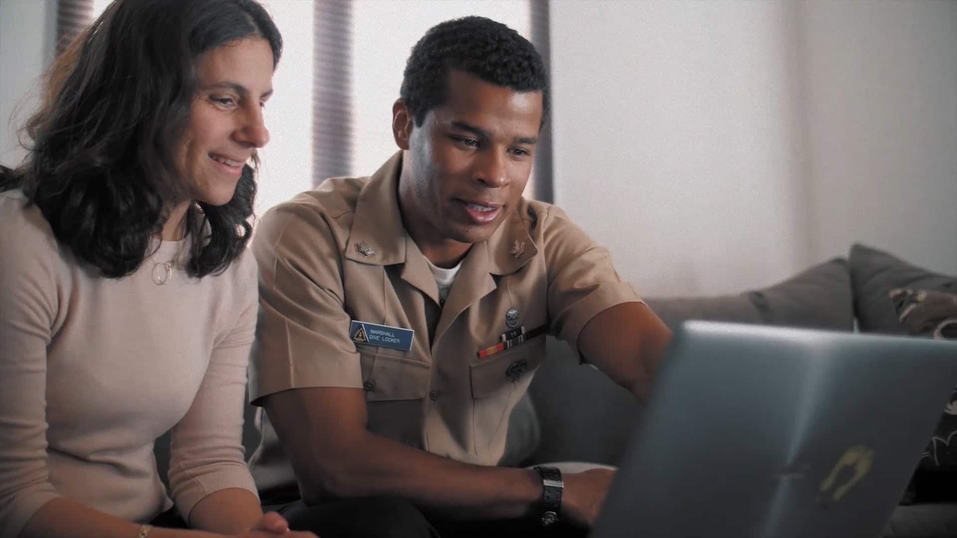 Active duty service member reviewing home purchase information with realtor.